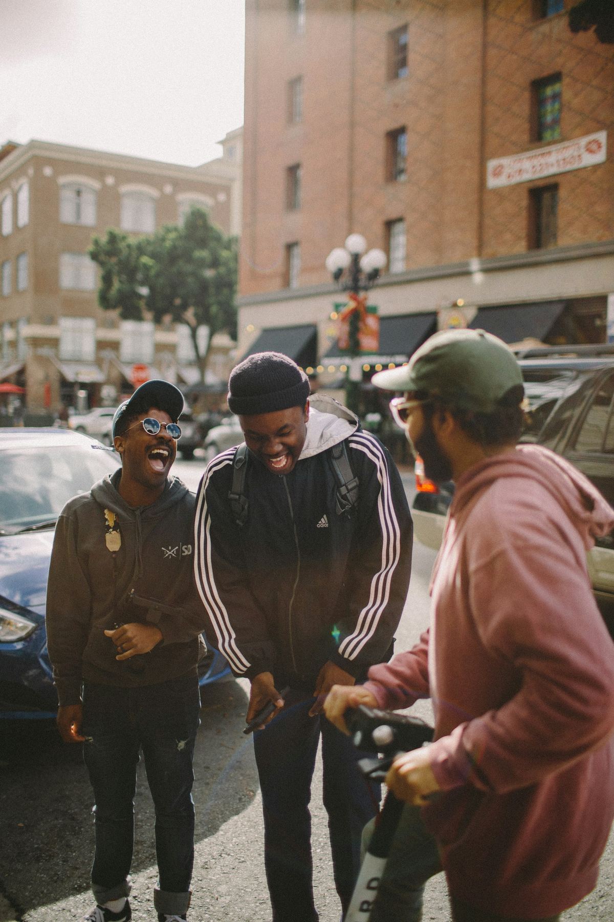 Friends laughing together on a neighbourhood street
